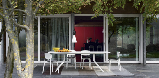 Oops Round Extensible Dining Table by Kristalia — white lacquered top, white lacquered aluminium legs, outdoor setting